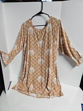Living Hula dress tan background with a white floral and lattice pattern